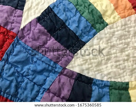 Patchwork Cotton Fabric Quilt Pattern with Curved Stripes in Rainbow Colors Royalty-Free Stock Photo #1675360585
