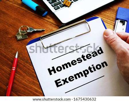 Man is reading Homestead Exemption at the home. Royalty-Free Stock Photo #1675430632