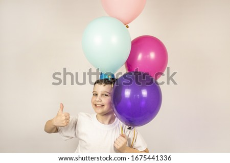 Joyful boy posing during his birthday. Boy with balloons. Banner. copyspace