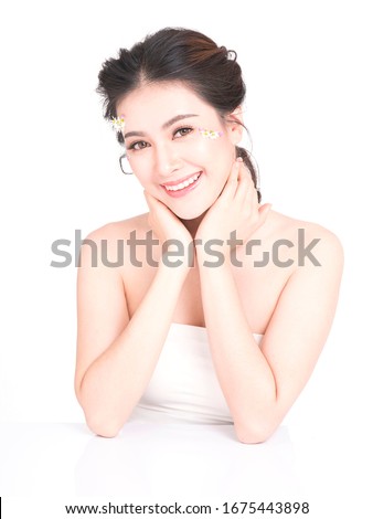Portrait Asia women Makeup in glass skin with natural cosmetics and on the face with flowers on a white background.