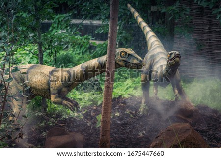 Wild Dinosaur velociraptor couple on a park