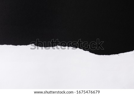 White paper with torn edges isolated with black colored paper background inside. Good paper texture Royalty-Free Stock Photo #1675476679