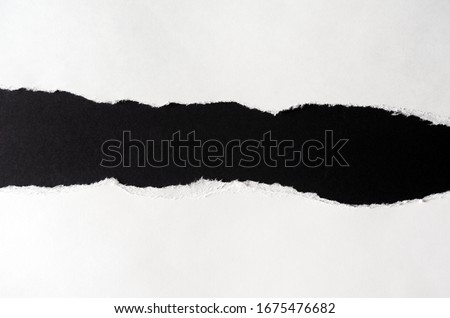 White paper with torn edges isolated with black colored paper background inside. Good paper texture Royalty-Free Stock Photo #1675476682