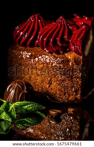 chocolate cheesecake with cherry cream on a black background close-up with mirror reflection