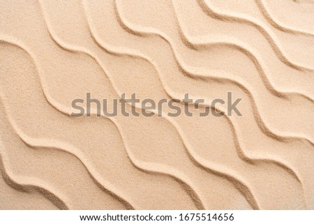 Minimal summer beach sand background, vacation and travel concept, Flat lay top view copy space, exotic concept. Creative layout of sand waves.