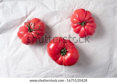 Ugly tomatoes on craft paper background. Concept of zero waste production. Top view. Copy space. Non gmo vegetables