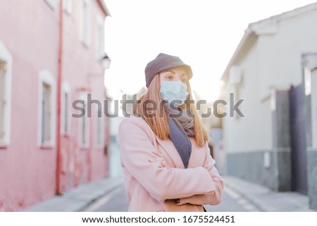 caucasian woman in the street wearing protective mask. corona virus concept