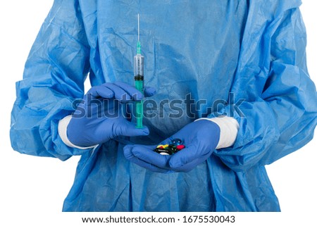 Close up picture of surgeon with protective uniform and gloves holding injection and medical drugs