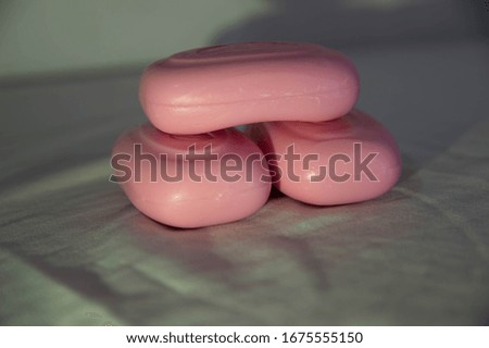 Pink hand soaps on white background