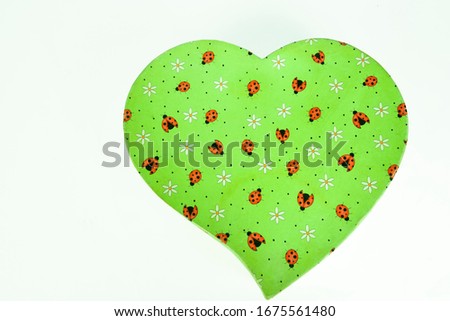 beautiful heart shaped gift box with green texture with patterned images on white background