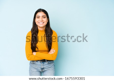 Young indian woman isolated on blue background laughing and having fun. Royalty-Free Stock Photo #1675593301
