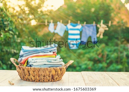 washing baby clothes. Linen dries in the fresh air. Selective focus. nature. Royalty-Free Stock Photo #1675603369