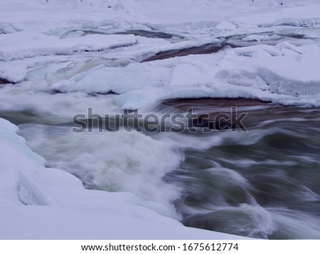 moving river in winter, Storforsen