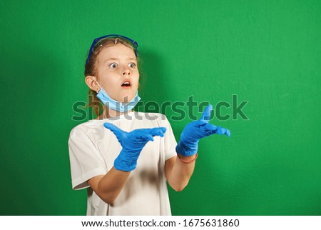 young doctor in a mask and gloves on a green background
