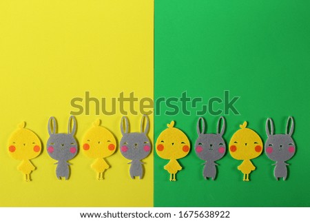 Easter colorful background, shapes of chicken and bunnies on green yellow background . Traditional signs and symbols.