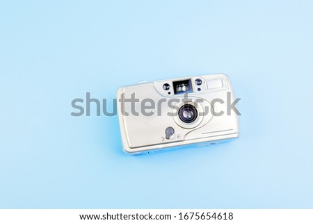 Kyiv, Ukraine - March 16, 2020.Retro film photo camera on blue background. Top view, place for text. Photo shooting. Pop Art. Creative Retro Design. Hipster Trendy Vintage Accessories. 