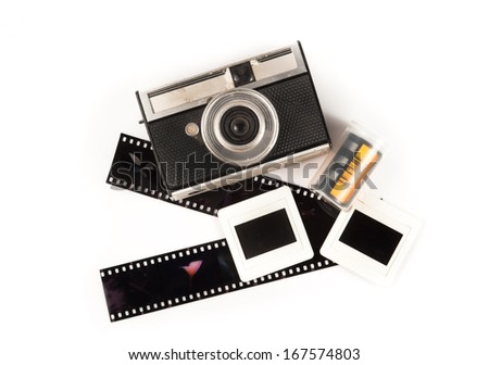 old camera and blank film strip on White background
