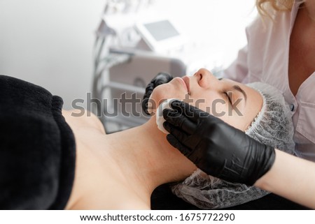 A closeup photo of a girl doing face lifting massage.