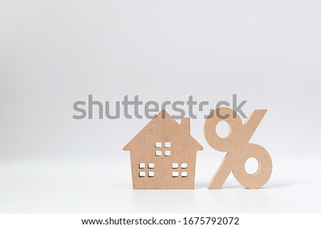 Interest rate property investment mortgage concept. Percentage  and house sign symbol icon wooden on white background