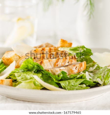 Chicken Caesar salad on the white plate
