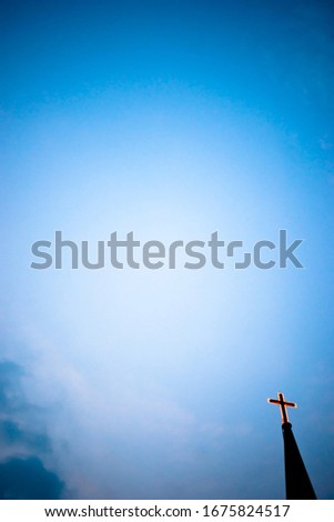 This is a picture of a cross taken with a sky view.