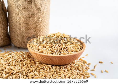 Sack filled with grain and a bowl of oatmeal on a white background	
 Royalty-Free Stock Photo #1675826569