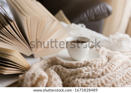 Books  on the bed and a cup of tea. Royalty-Free Stock Photo #1675828489