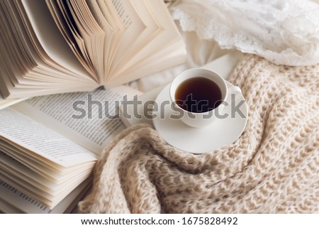 Many books  on the bed and a cup of coffee. Royalty-Free Stock Photo #1675828492