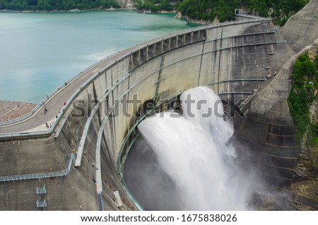 Kurobe Dam in water discharge for tourism Royalty-Free Stock Photo #1675838026