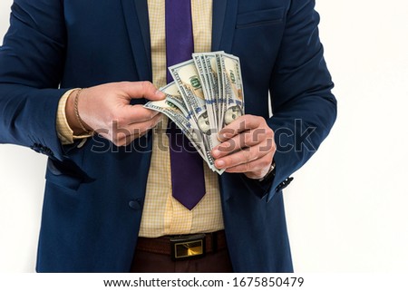 Businessman counts money isolated on white. A man in a suit is making a profit or a win. Account of dollars. Wealth concept