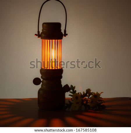 vintage still life of burning candle and  flower on table wood