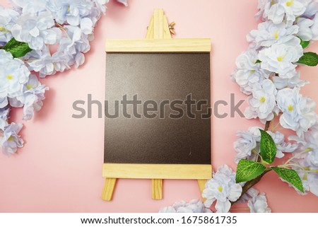 Empty Easel Space copy for text with Blooming flowers on pink background