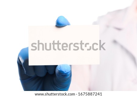 Doctor hand in sterile gloves holding card with text palce   isolated on white background 
