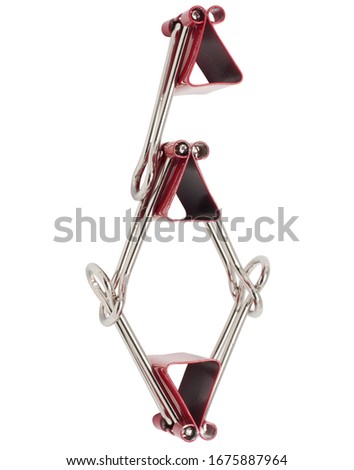 Numeral 6 red binder clips alphabet. Office metal foldback braces. Metal binder clips isolated on white background