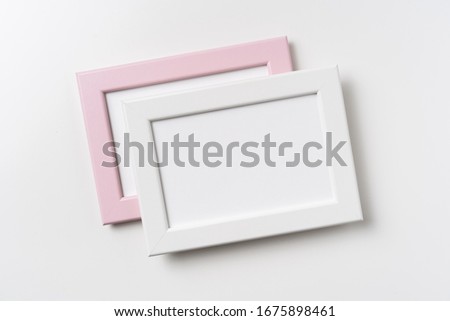 Design concept - top view of two pink and white wood photo frame isolated on white background for mockup, it's real photo, not 3D render