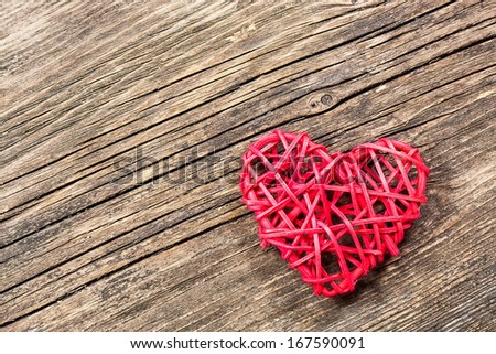 Red heart on wooden background