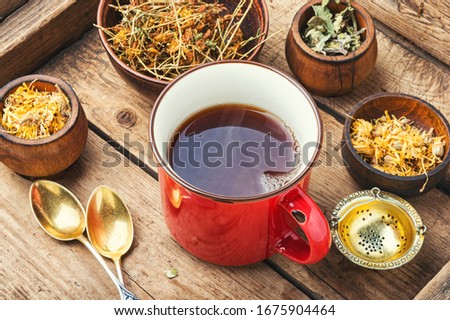 Cup with tea from medicinal herbs.Various herbal tea ingredients