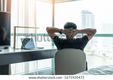 Life-work balance and city living life style concept of business man relaxing, take it easy in office room resting with thoughtful mind thinking of lifestyle quality looking forward to cityscape  Royalty-Free Stock Photo #1675920472