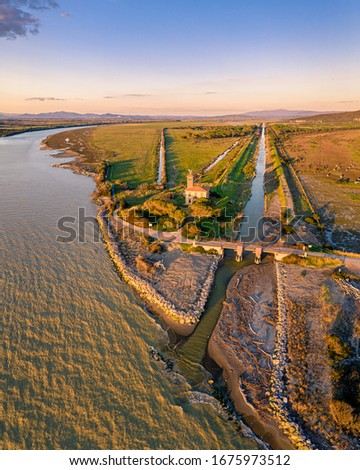 Aerial picture of the mouth of the river Ombrone in the natural park of Maremma (Tuscany)