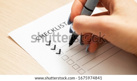 Woman filling free space on a checklist