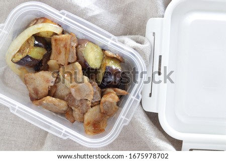 Chinese cuisine, deep fried eggplant and pork belly meat stir fried in storage box