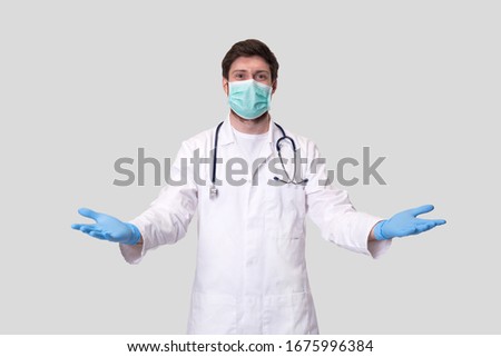 Man Doctor Hands Sides. Doctor Welcomes, Invites. Man Doctor Wearing Medical Mask and Gloves. Virus Concept Royalty-Free Stock Photo #1675996384