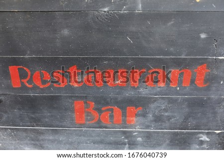 Restaurant and bar sign on wooden wall