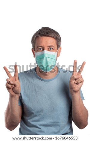 Caucasian man wearing a protection mask making victory sign isolated on a white background