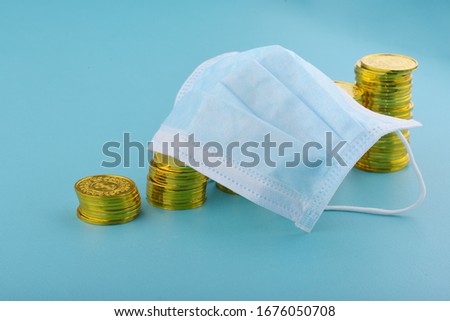 Masks and gold coins on blue background