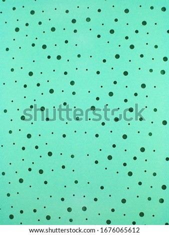 dark green hand made circles on light green background 