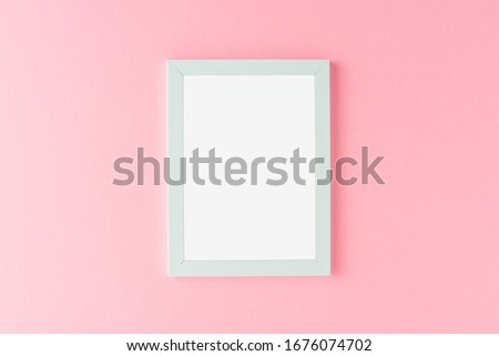 Blue picture frame on pink background. Mockup with copyspace