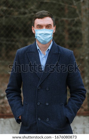 A thin man in a medical mask
