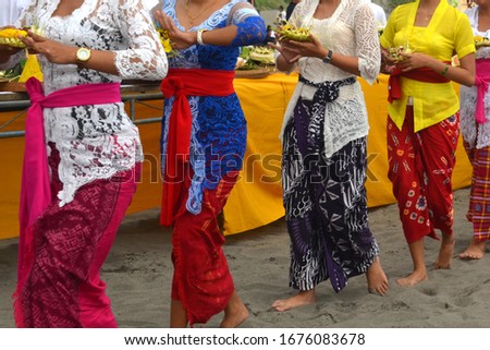Beautiful ladies wearing traditional costumes. Prayers in Hinduism ceremony, welcoming Caka New Year.