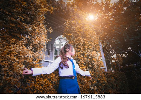 Girl sitting in a chair green tree background
